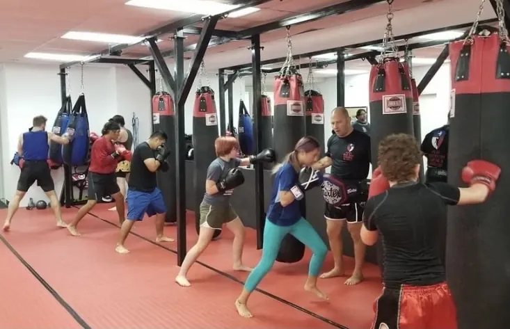 Adults of every age working combinations on the heavy bags