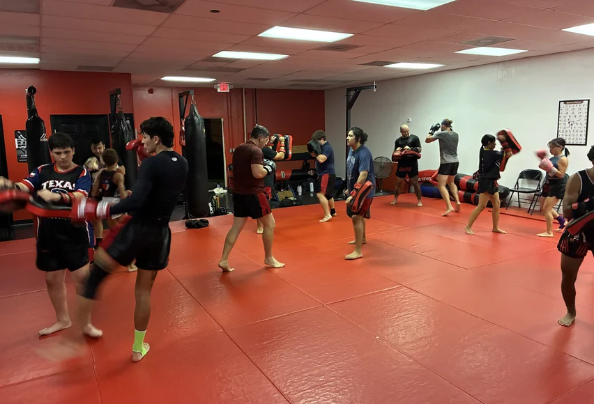 Students practice pad work together at our Webster gym