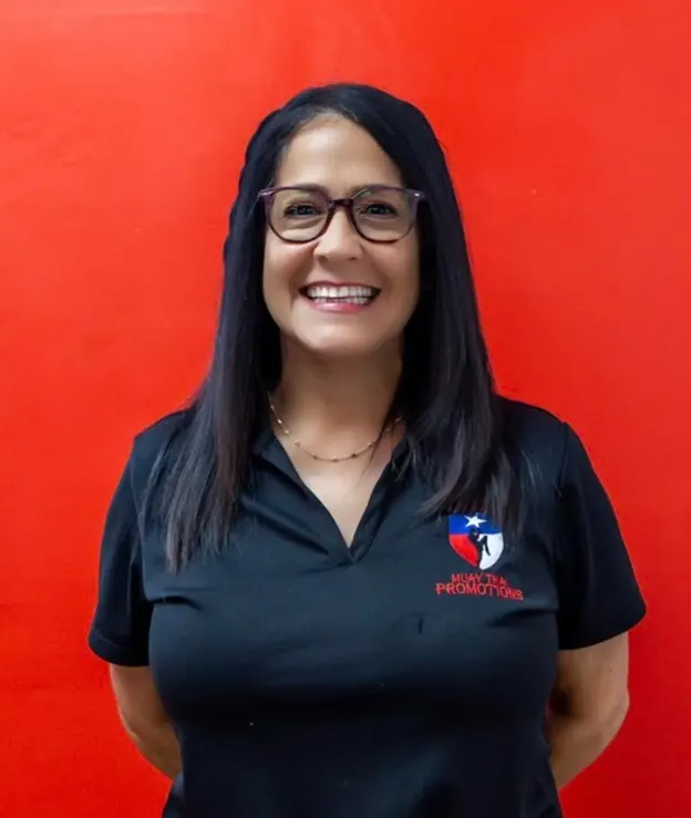 Jennifer Harris smiling in a Texas Muay Thai polo
